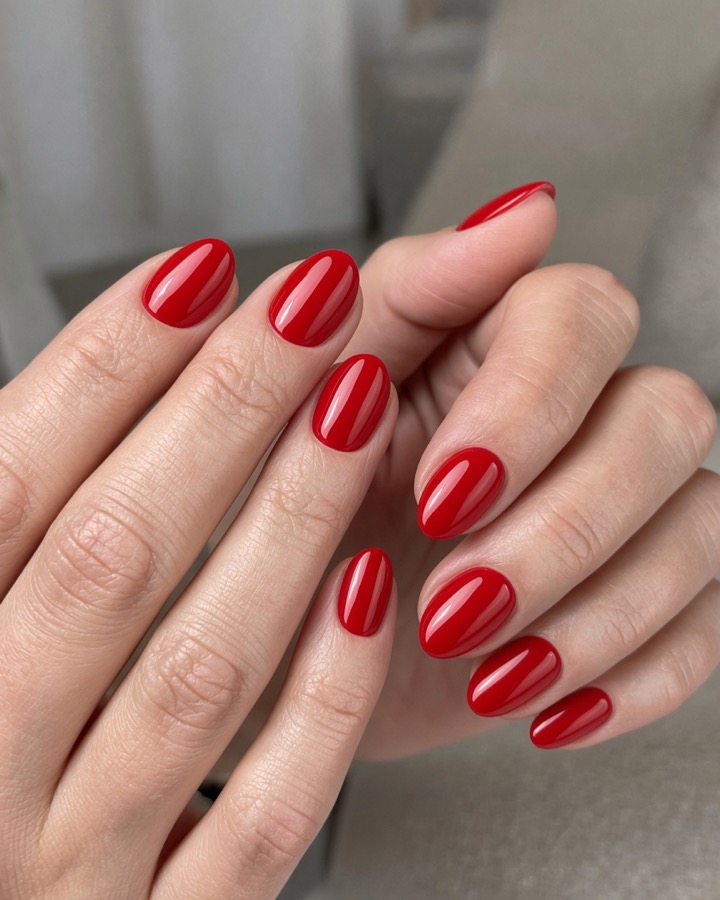 The same hands with red nails